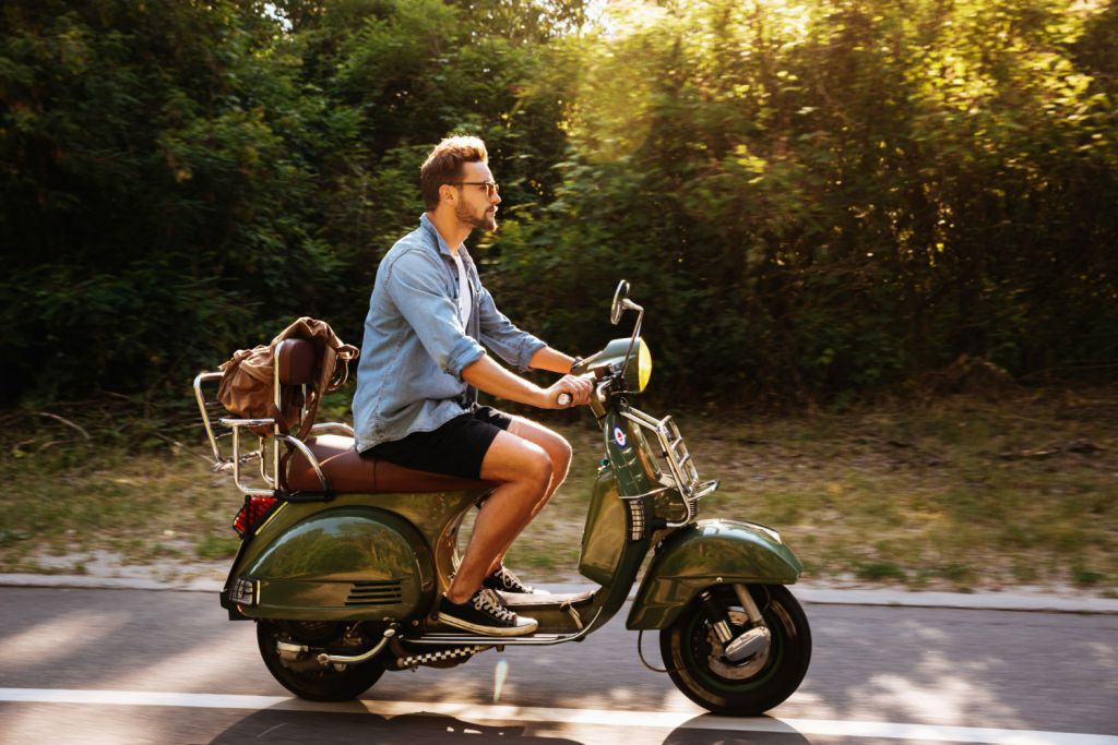 serious-young-bearded-man-scooter-outdoors