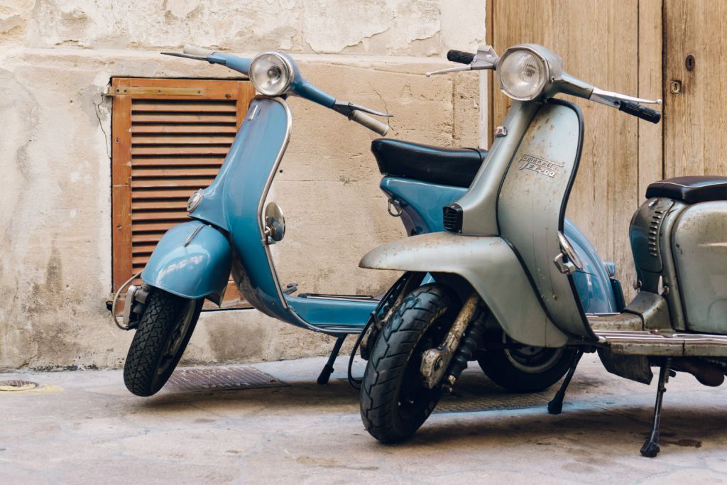 two-vintage-scooters-parked-street